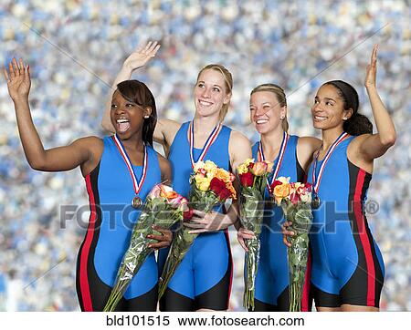 Stock Photography - Women athletes with medals holding flower bouquets. Fotosearch