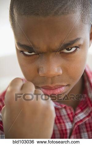 African American boy frowning and making a fist View Large Photo Image Stock Photograph - African American boy frowning and making a fist. Fotosearch