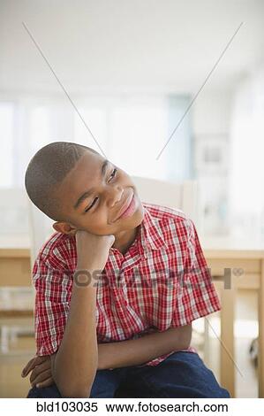 African American boy sitting with head in hands thinking View Large Photo Image Stock Photography - African American boy sitting with head in hands thinking. Fotosearch