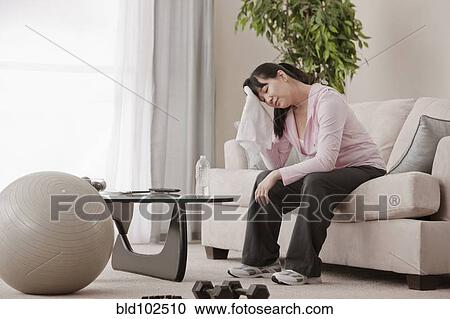 Asian woman relaxing after exercise View Large Photo Image Stock Image - Asian woman relaxing after exercise. Fotosearch
