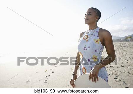 Stock Image - Black woman enjoying the beach. Fotosearch