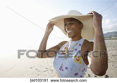 Black woman in hat enjoying the beach View Large Photo Image Stock Image - Black woman in hat enjoying the beach. Fotosearch