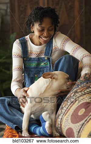 Black woman petting her dog View Large Photo Image Stock Photo - Black woman petting her dog. Fotosearch