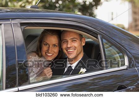 Caucasian bride and groom in back seat of car View Large Photo Image Stock Image - Caucasian bride and groom in back seat of car. Fotosearch