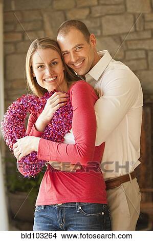 Caucasian couple holding heart View Large Photo Image Picture - Caucasian couple holding heart. Fotosearch