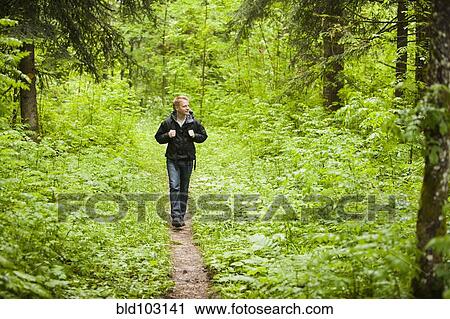 Caucasian man hiking in woods View Large Photo Image Stock Image - Caucasian man hiking in woods. Fotosearch