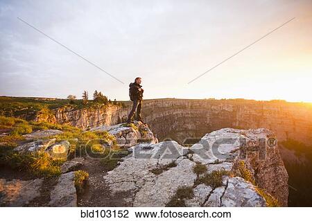 Caucasian man standing on remote cliff View Large Photo Image Stock Image - Caucasian man standing on remote cliff. Fotosearch