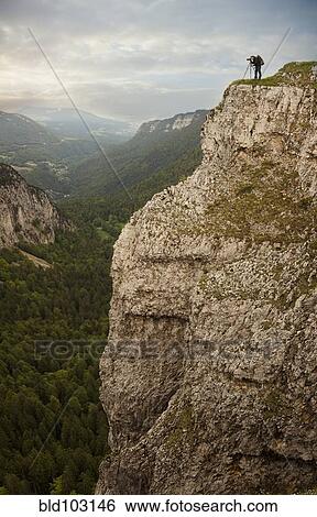Caucasian man taking photographs from edge of cliff View Large Photo Image Stock Photograph - Caucasian man taking photographs from edge of cliff. Fotosearch