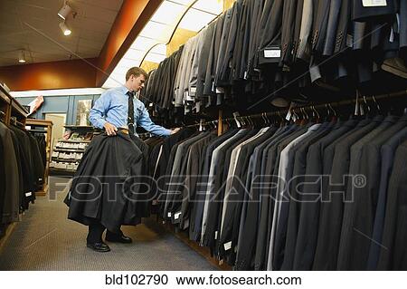 Caucasian man working in men's clothing store View Large Photo Image Stock Image - Caucasian man working in men's clothing store. Fotosearch