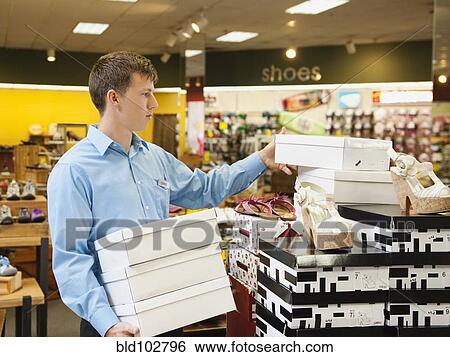 Caucasian man working in shoe store View Large Photo Image Stock Photograph - Caucasian man working in shoe store. Fotosearch
