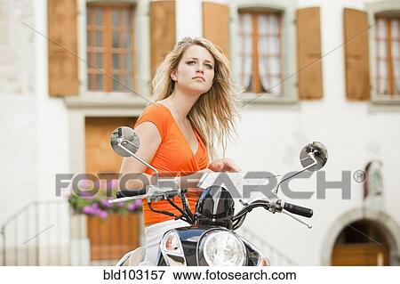 Caucasian teenager sitting on scooter View Large Photo Image Stock Photo - Caucasian teenager sitting on scooter. Fotosearch
