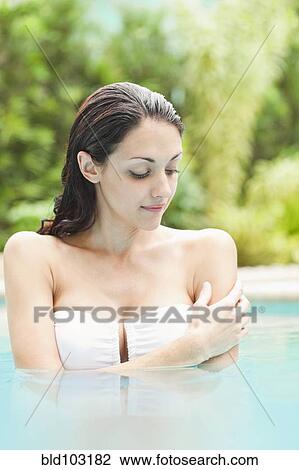 Caucasian woman enjoying swimming pool View Large Photo Image Stock Image - Caucasian woman enjoying swimming pool. Fotosearch