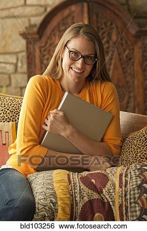 Caucasian woman holding laptop View Large Photo Image Stock Photograph - Caucasian woman holding laptop. Fotosearch