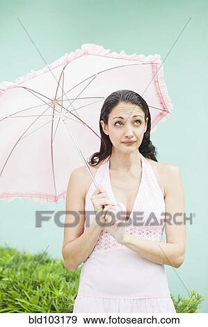 Stock Photo - Caucasian woman holding parasol. Fotosearch