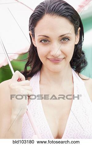 Caucasian woman holding umbrella View Large Photo Image Stock Image - Caucasian woman holding umbrella. Fotosearch