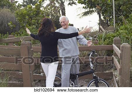 Caucasian woman hugging man on bicycle View Large Photo Image Picture - Caucasian woman hugging man on bicycle. Fotosearch