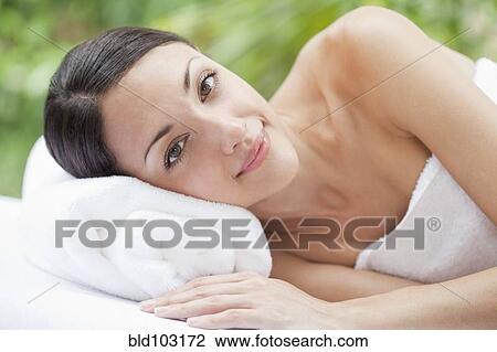 Caucasian woman laying on towel View Large Photo Image Stock Image - Caucasian woman laying on towel. Fotosearch