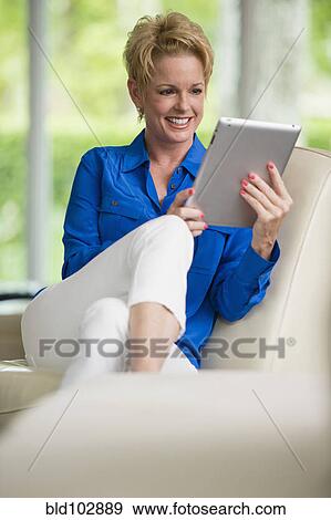 Stock Photo - Caucasian woman using digital tablet. Fotosearch