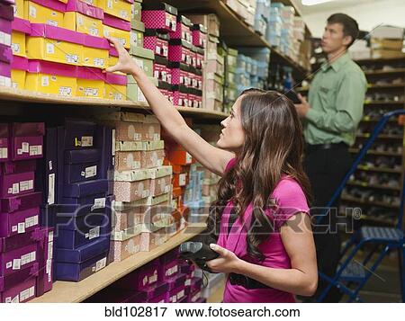Stock Photo - Caucasian woman working in stockroom. Fotosearch