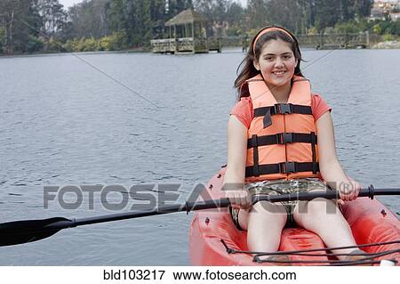 Chilean girl rowing in kayak View Large Photo Image Stock Photo - Chilean girl rowing in kayak. Fotosearch