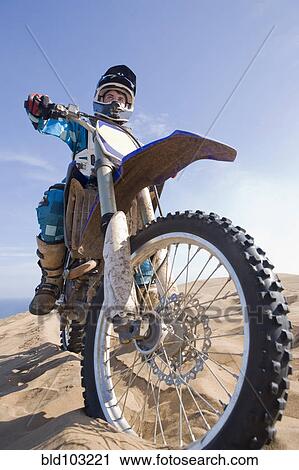 Chilean teenager riding motorcycle on sand dune View Large Photo Image Stock Image - Chilean teenager riding motorcycle on sand dune. Fotosearch