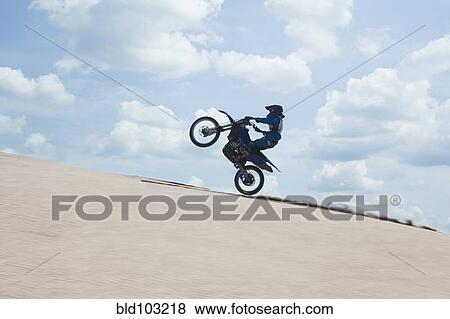 Chilean teenager riding motorcycle on sand dune View Large Photo Image Stock Photo - Chilean teenager riding motorcycle on sand dune. Fotosearch