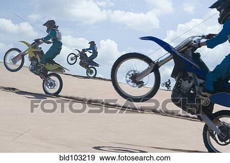 Chilean teenagers riding motorcycle on sand dune View Large Photo Image Stock Photo - Chilean teenagers riding motorcycle on sand dune. Fotosearch