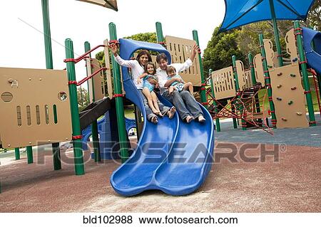 Family sliding down slide on playground View Large Photo Image Stock Photo - Family sliding down slide on playground. Fotosearch