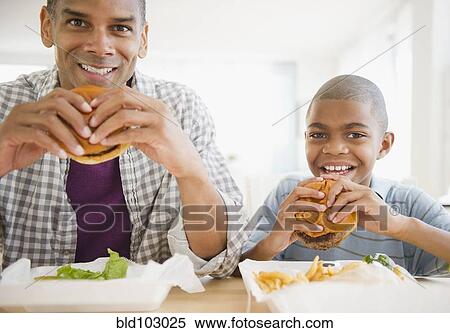 Father and son eating hamburgers View Large Photo Image Stock Photography - Father and son eating hamburgers. Fotosearch