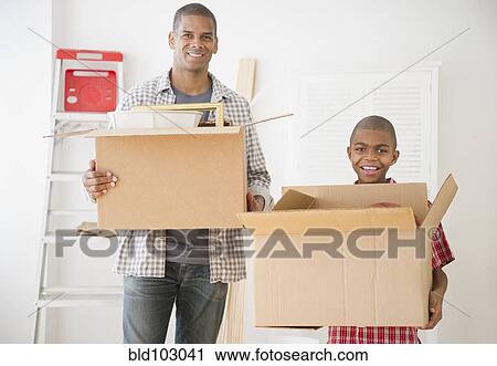 Father and son holding moving boxes View Large Photo Image Stock Image - Father and son holding moving boxes. Fotosearch