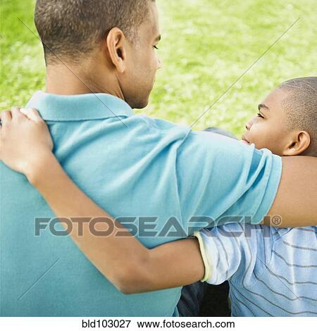 Stock Photo - Father and son hugging. Fotosearch
