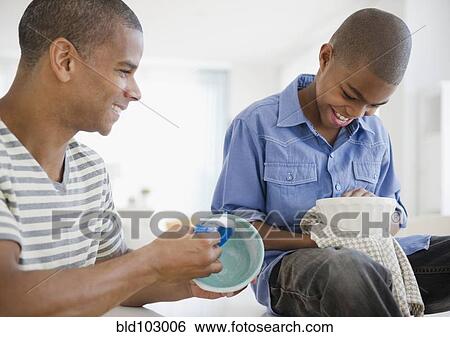 Father and son washing dishes View Large Photo Image Stock Photograph - Father and son washing dishes. Fotosearch