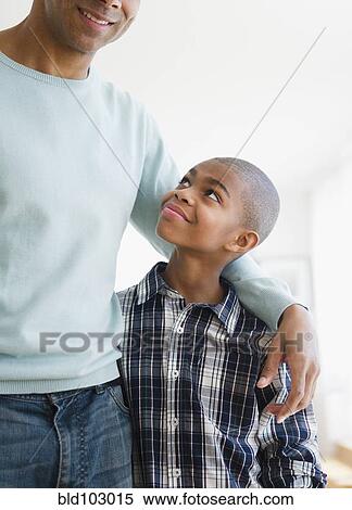 Stock Photography - Father hugging son. Fotosearch