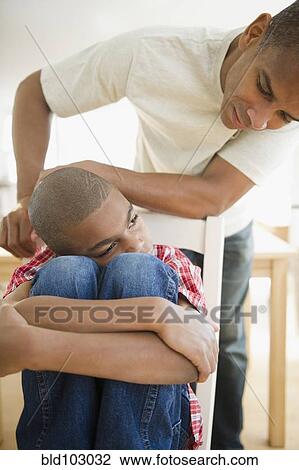 Father talking to sulking son View Large Photo Image Stock Image - Father talking to sulking son. Fotosearch