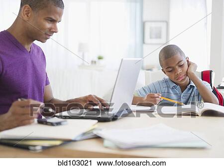 Father working and son doing homework View Large Photo Image Stock Image - Father working and son doing homework. Fotosearch