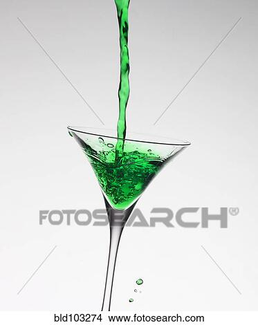 Green liquid filling martini glass View Large Photo Image Picture - Green liquid filling martini glass. Fotosearch