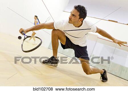 Stock Photo - Hispanic couple playing squash. Fotosearch