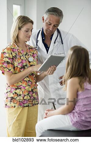 Stock Image - Hispanic girl having checkup in doctor's office. Fotosearch