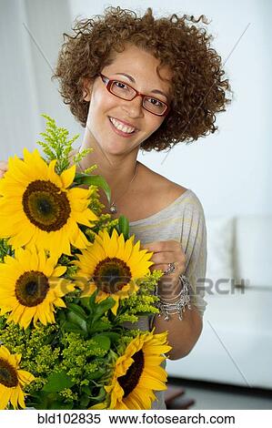 Hispanic woman arranging sunflowers View Large Photo Image Stock Photography - Hispanic woman arranging sunflowers. Fotosearch