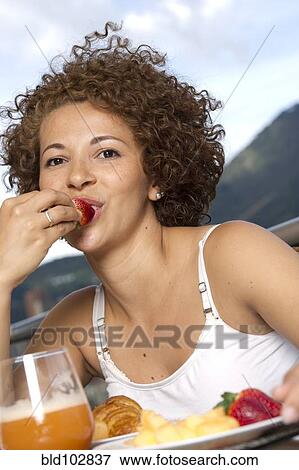Hispanic woman eating breakfast View Large Photo Image Stock Photo - Hispanic woman eating breakfast. Fotosearch