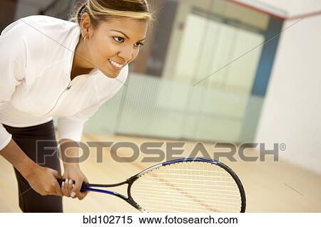 Stock Photography - Hispanic woman playing squash. Fotosearch