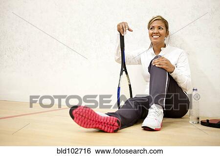 Hispanic woman relaxing on squash court View Large Photo Image Stock Photograph - Hispanic woman relaxing on squash court. Fotosearch