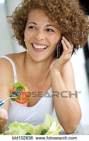 Hispanic woman talking on cell phone View Large Photo Image Stock Photograph - Hispanic woman talking on cell phone. Fotosearch