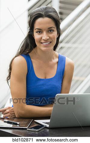Hispanic woman using laptop View Large Photo Image Stock Image - Hispanic woman using laptop. Fotosearch