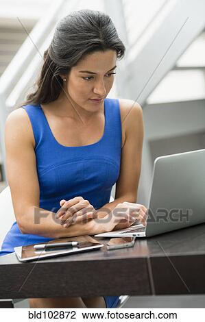 Hispanic woman using laptop View Large Photo Image Stock Image - Hispanic woman using laptop. Fotosearch