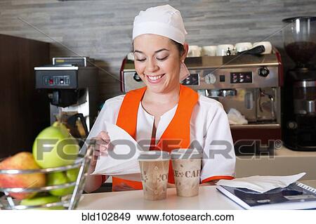 Stock Photo - Hispanic woman working in cafe. Fotosearch