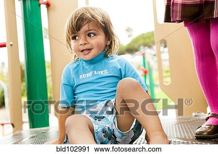 Mixed race boy on playground structure View Large Photo Image Stock Image - Mixed race boy on playground structure. Fotosearch