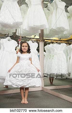 Mixed race girl trying on white dress View Large Photo Image Stock Image - Mixed race girl trying on white dress. Fotosearch