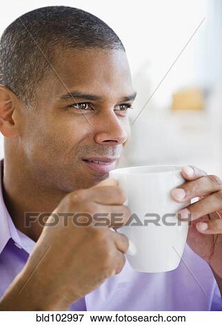 Mixed race man drinking coffee View Large Photo Image Stock Photo - Mixed race man drinking coffee. Fotosearch