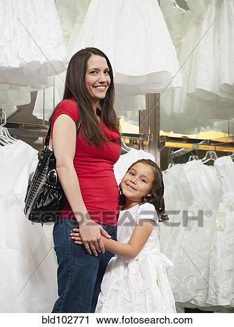 Mixed race mother and daughter in dress store View Large Photo Image Stock Image - Mixed race mother and daughter in dress store. Fotosearch